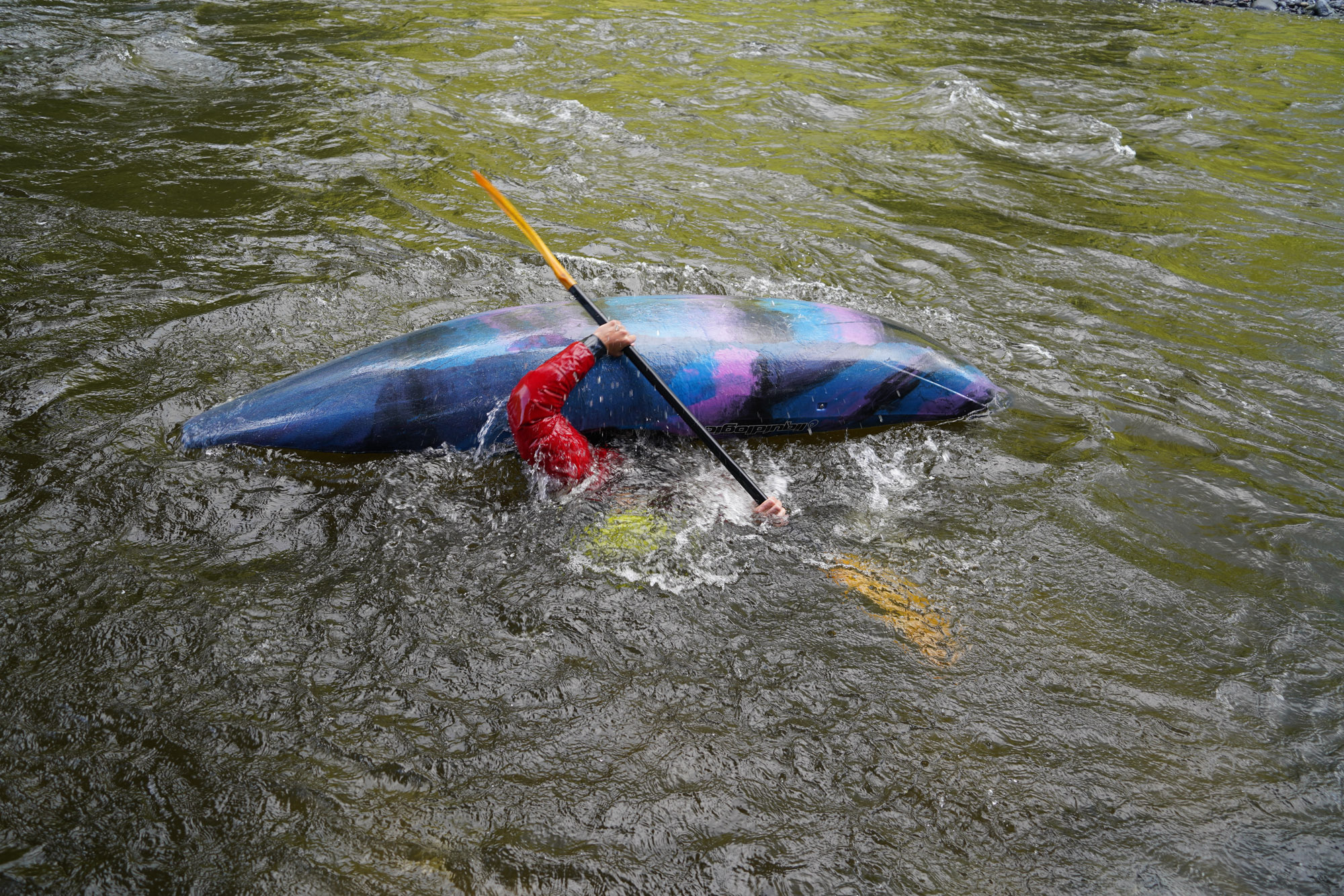 The author executes a roll with the Sherpa Paddle