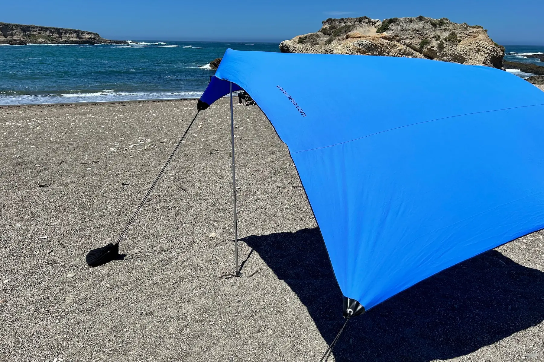 The Neso 1 beach tent set up on a beach by the Pacific Ocean