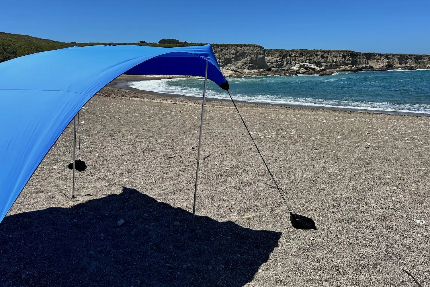 The Neso 1 beach tent set up on a rocky beach facing the Pacific Ocean