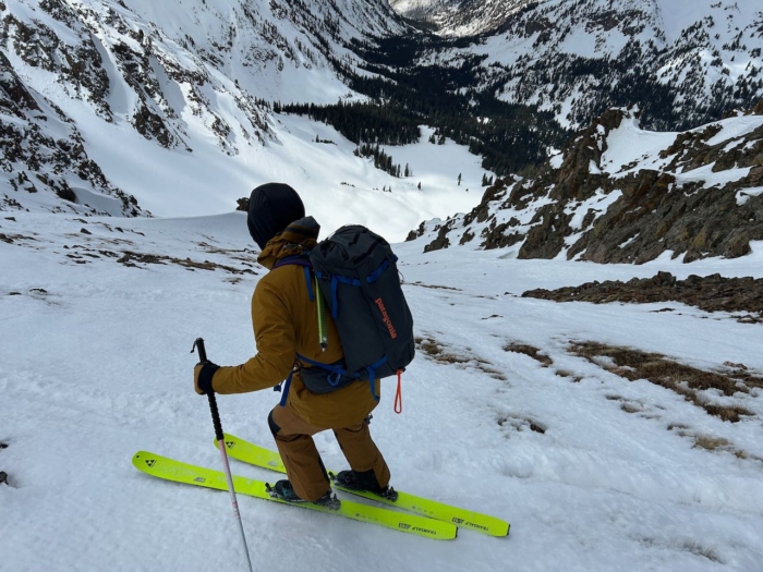 man wearing Outdoor Research Cirque pants on skiing on slope