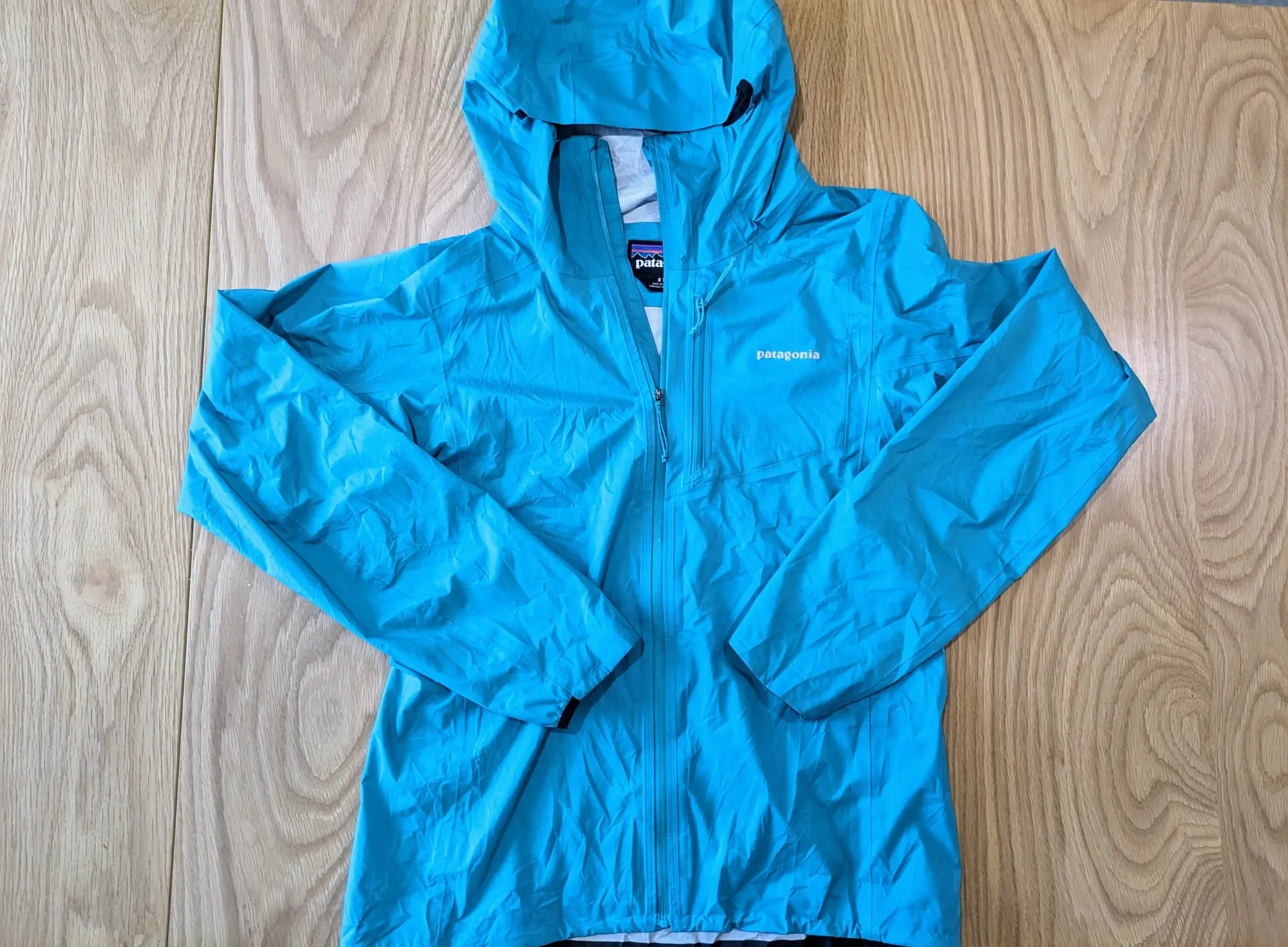 The front profile of the Storm Racer, showing the sleeves, full zip, and front pocket