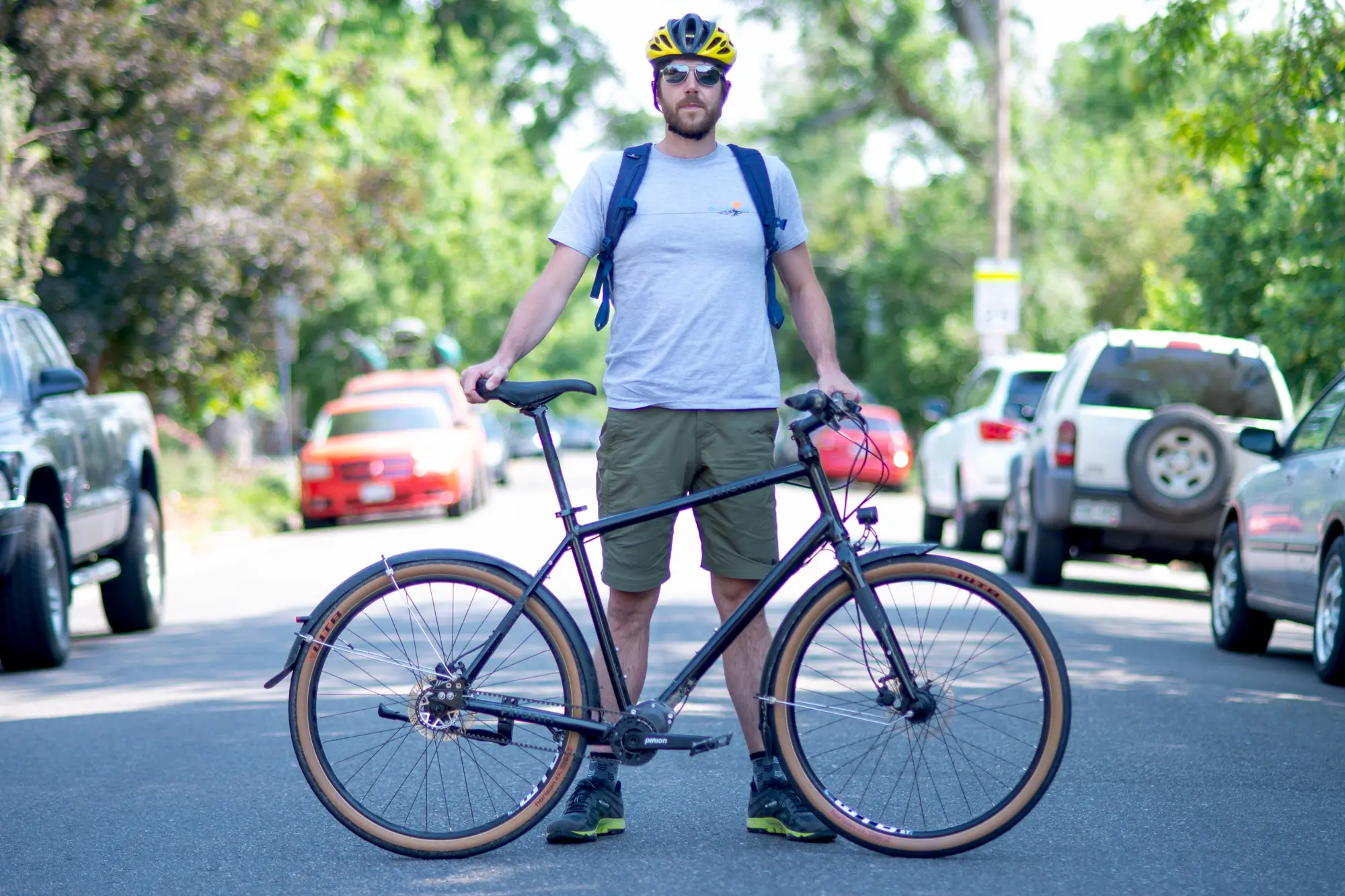 Adam Ruggerio standing with his Priority 600 commuter bike on a city street
