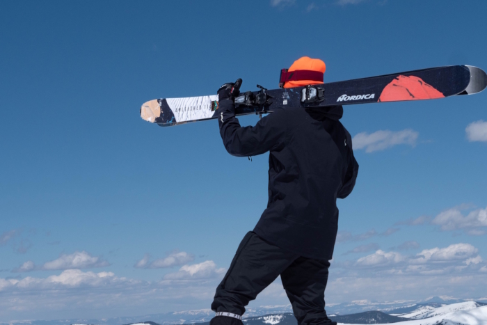 Skier carrying Nordica Unleashed skis