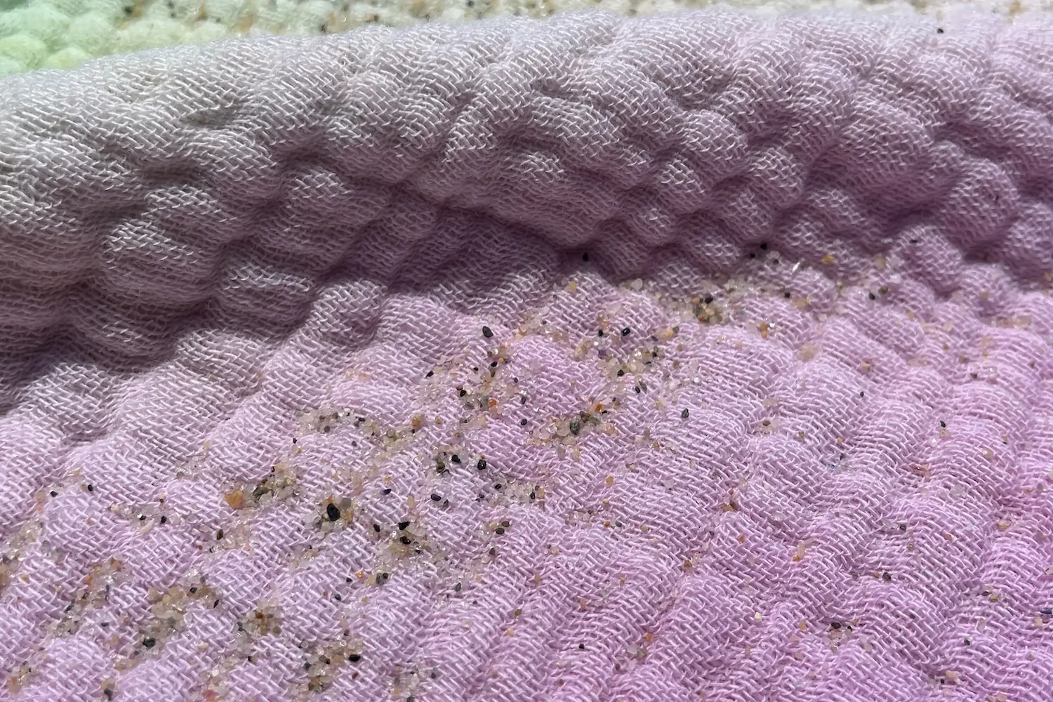 Close-up of beach sand on the Sand Cloud Party Blanket Turkish Cotton beach towel