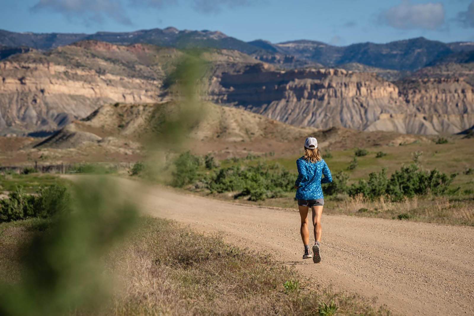 Woman-running-on-beautiful-road-at-sunrise