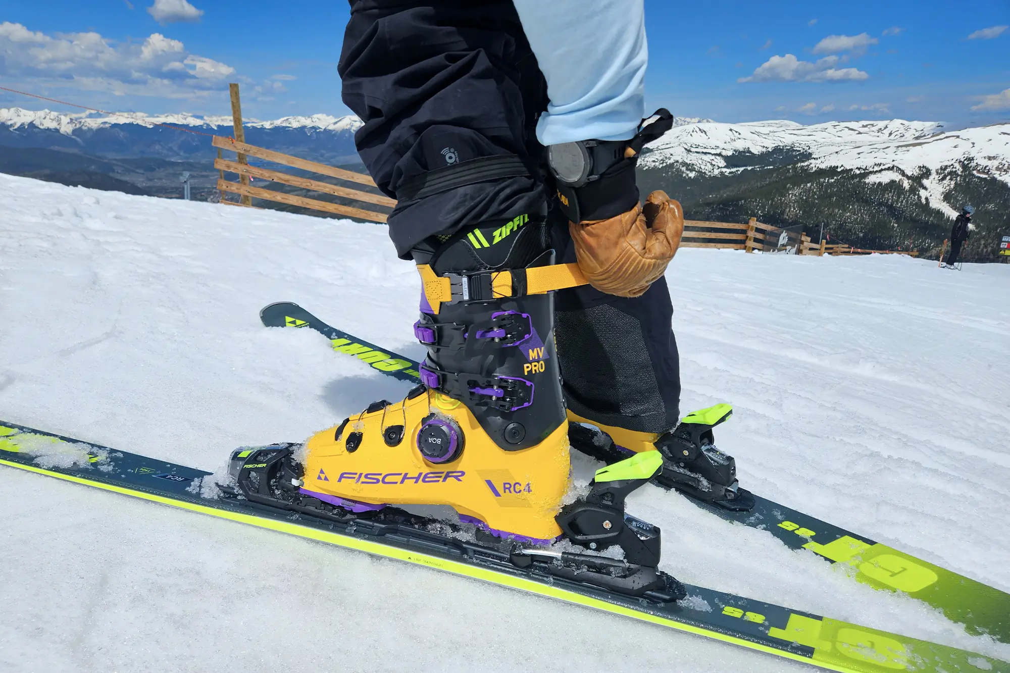 close up of man on slope adjusting fischer rc4 pro mv boa ski boot 