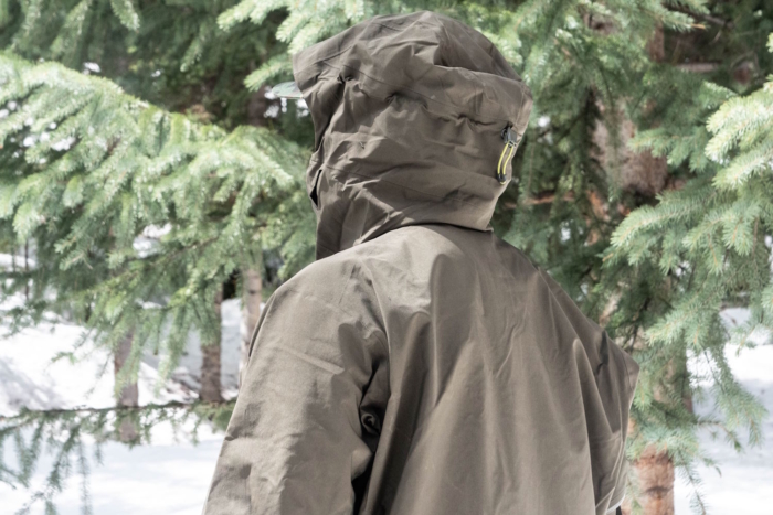 Back view of a person in a Rab Latok jacket amidst snowy tree