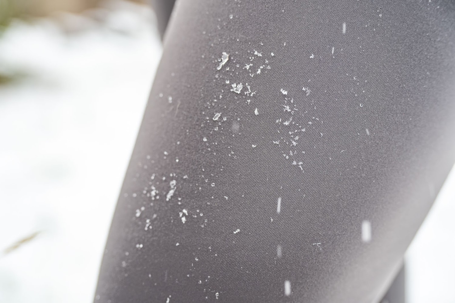 Close-up of defroster speed tights with snow falling on them