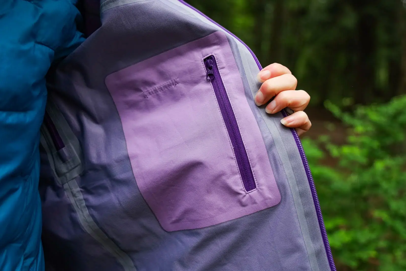 woman showing highest peak 3l interior zippered pocket