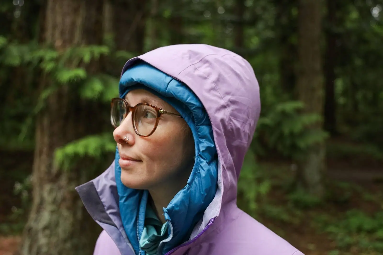 close up woman wearing highest peak 3l rain jacket with hood on
