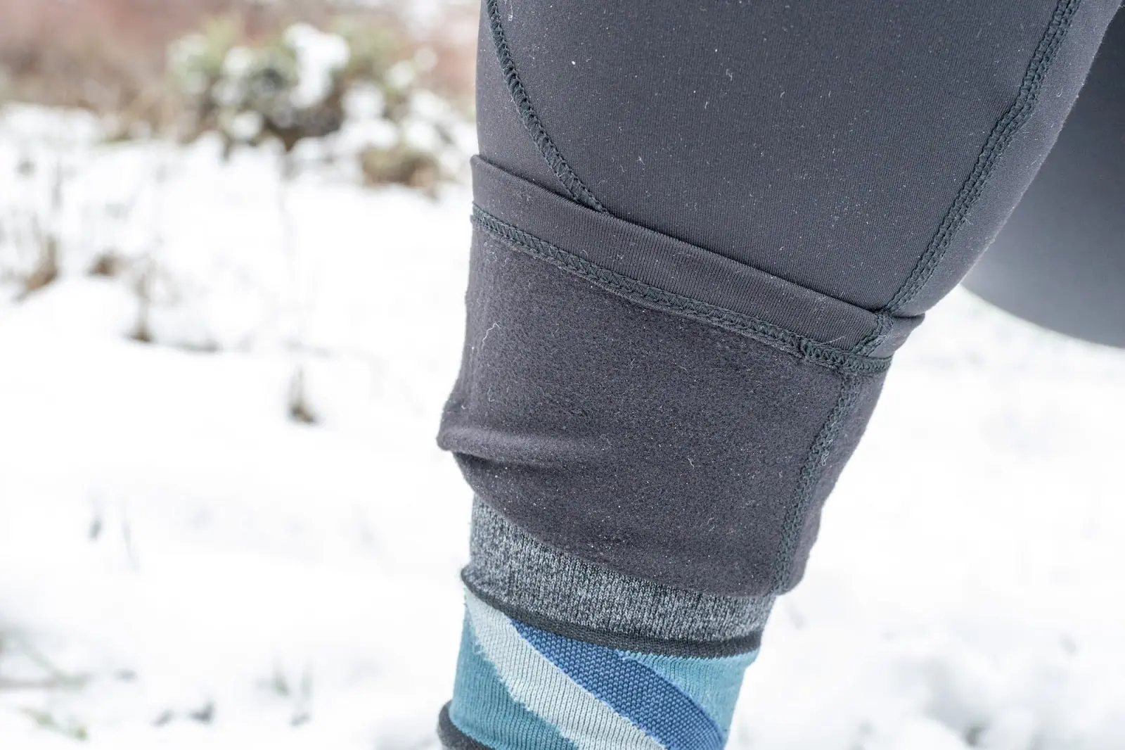 close up of the north face winter warm pro tights showcasing integrated fleece and visible pilling around ankles