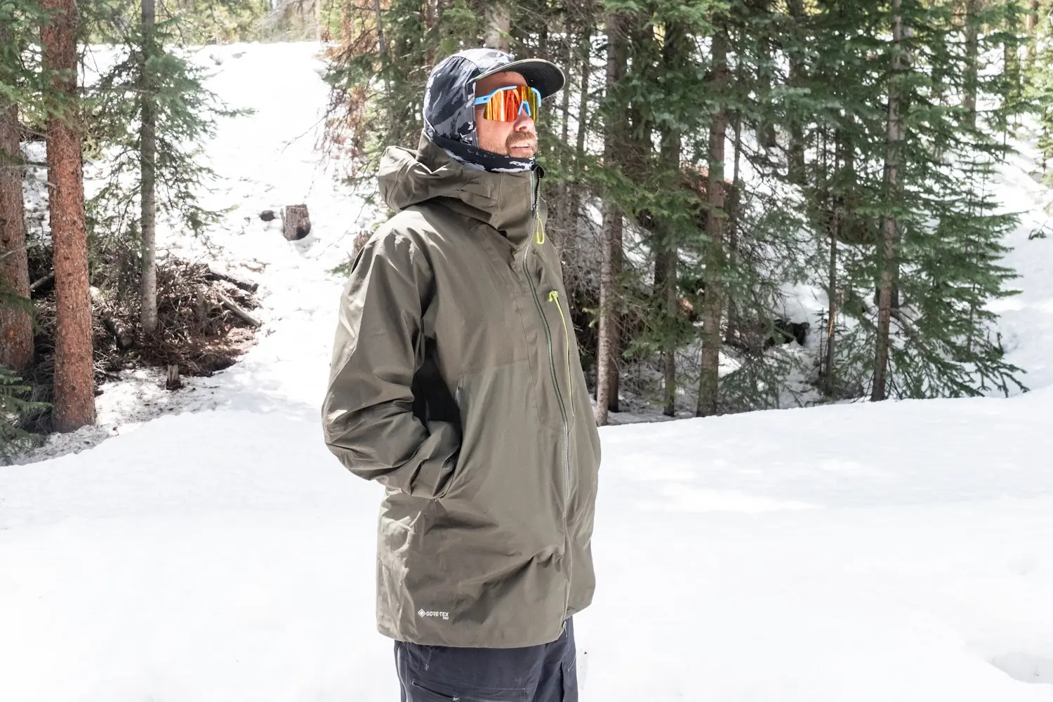 Man in rab latok jacket standing in a snowy forest