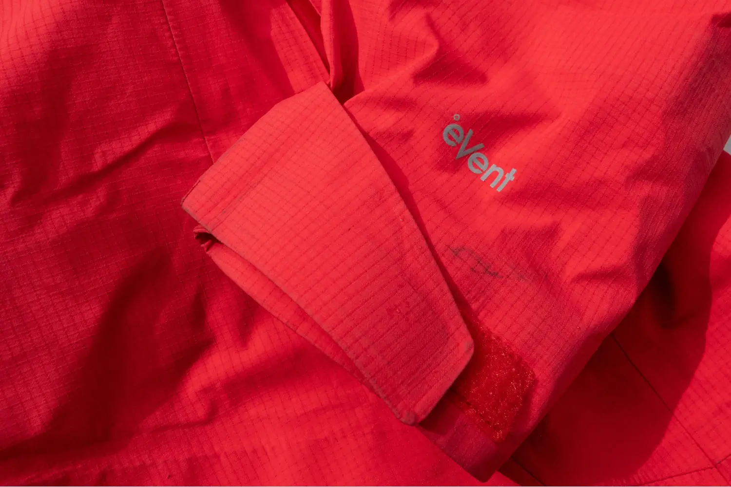 Close-up of a red 3L ski jacket with an "eVent" logo on the sleeve