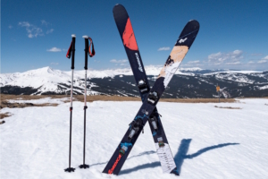 Nordica Unleashed 114 skis and poles on a snowy mountain