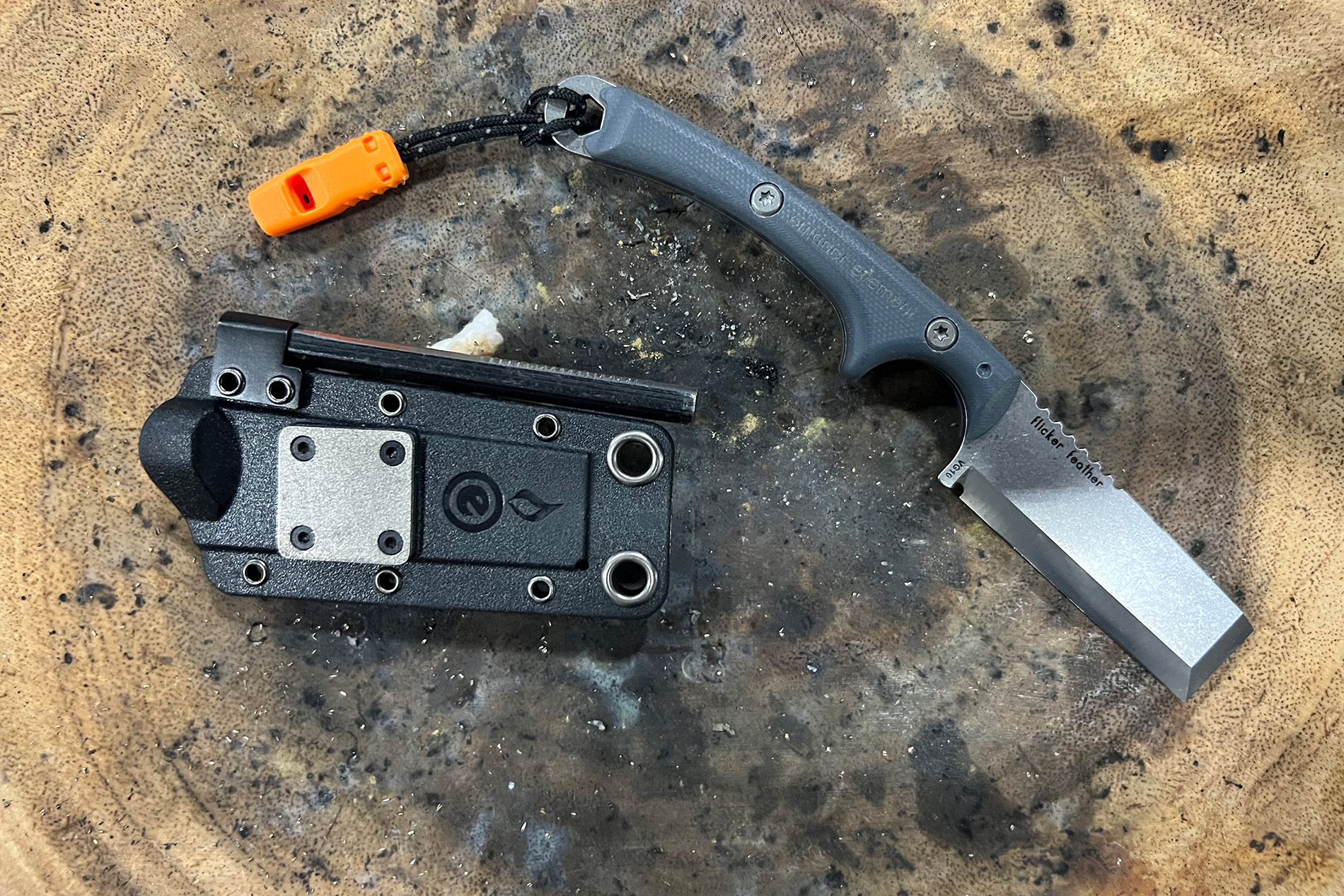 outdoor element flicker feather with sheath on stump