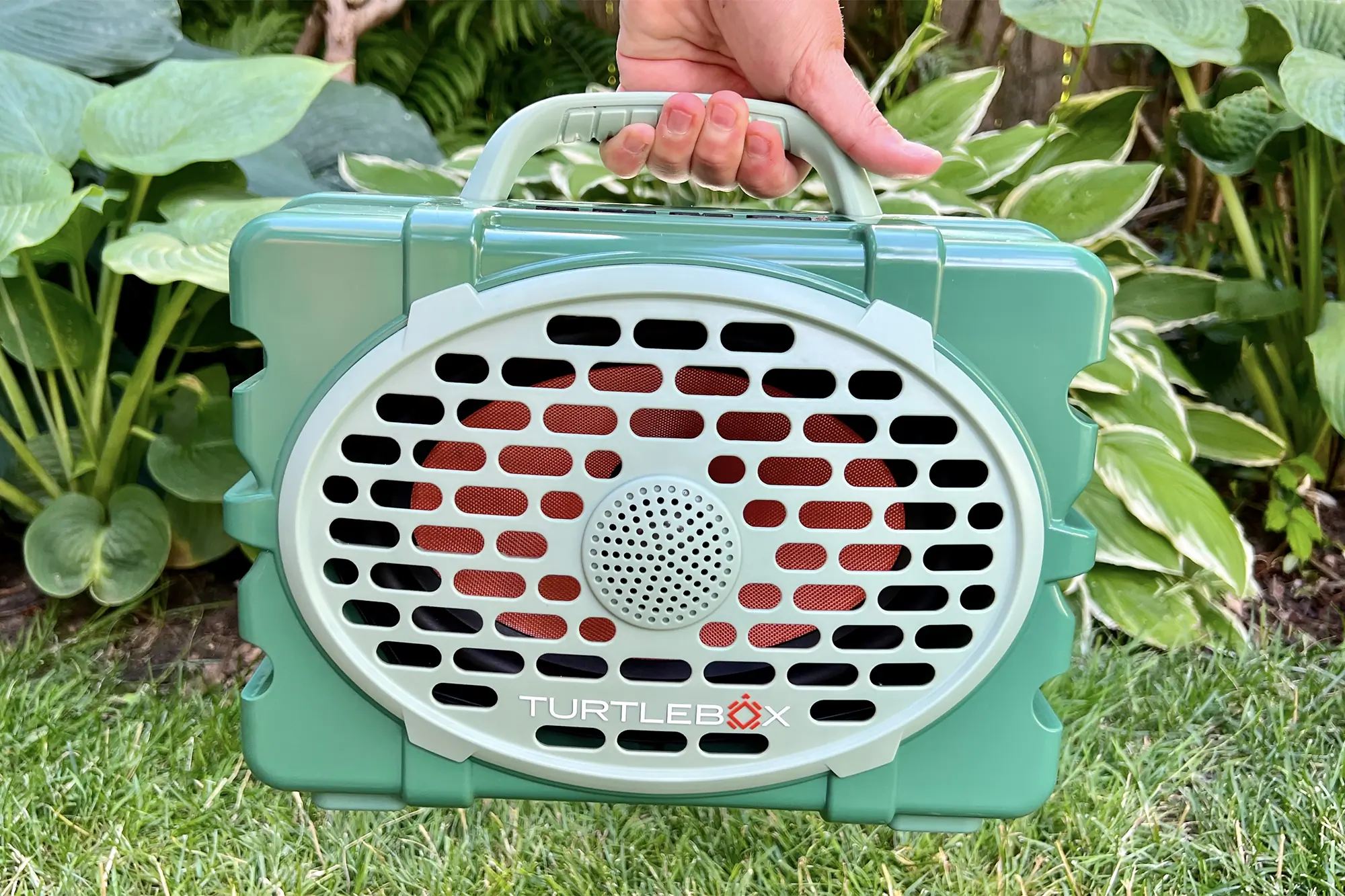 person holding turtlebox gen2 bluetooth speaker