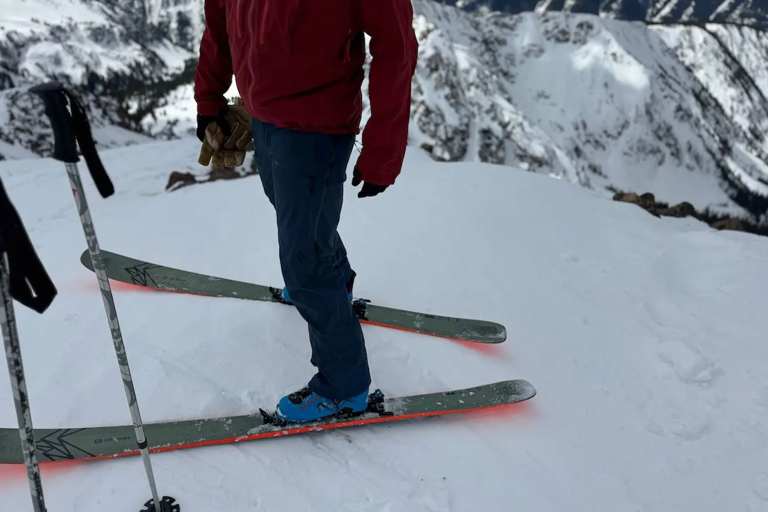 Skier with poles standing on snowy mountain slope waring Black diamond Recon Pants