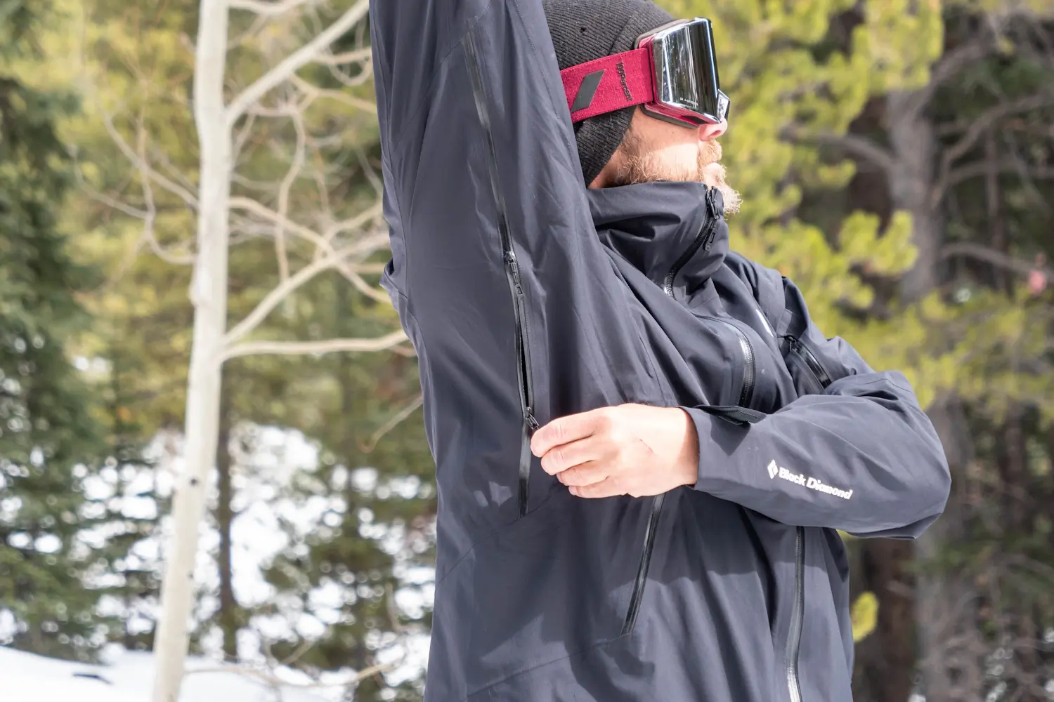 Man showcasing the jacket's underarm zipper ventilation