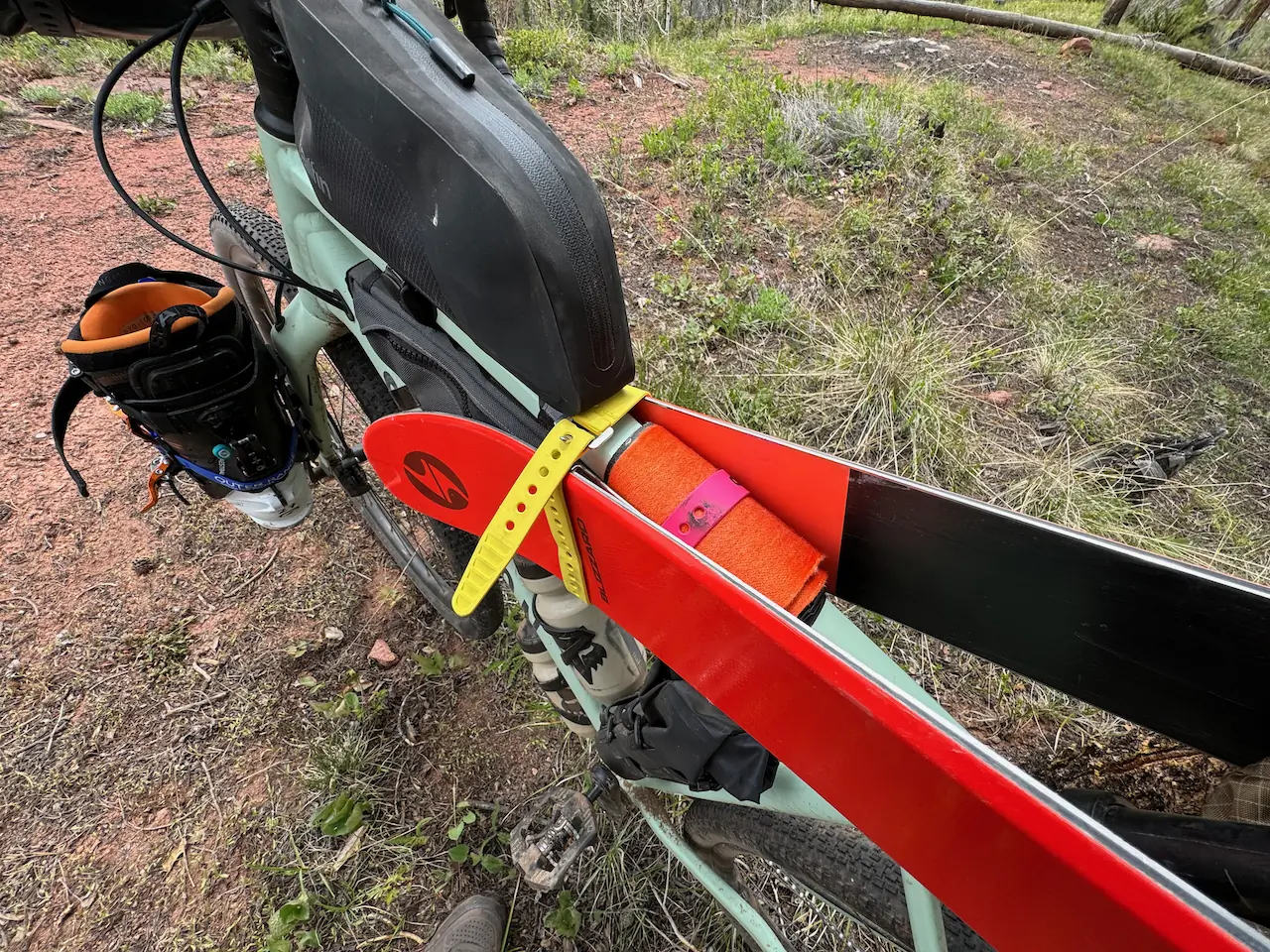 red skis strapped to the bike with bright yellow stripes