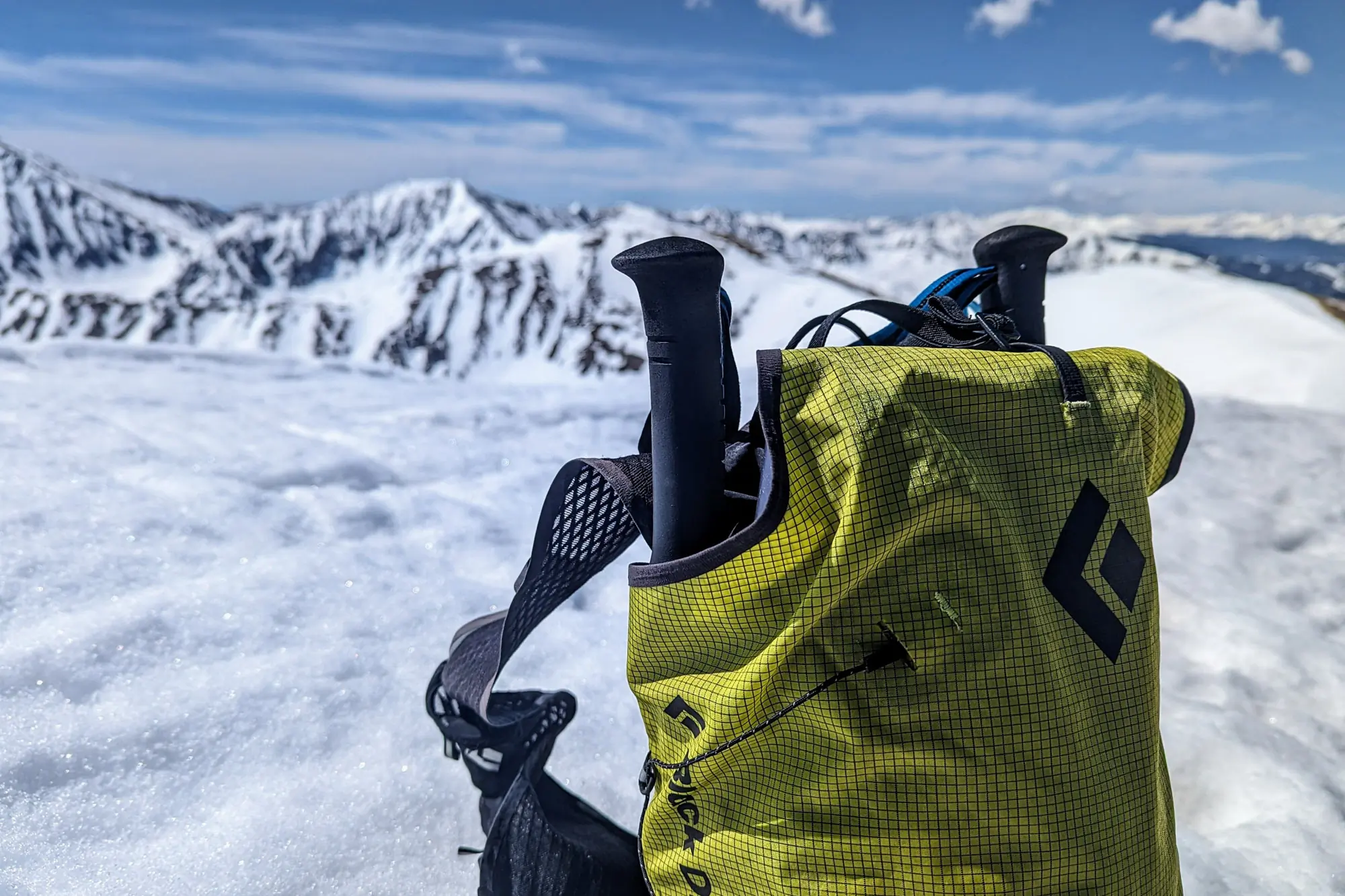 the distance carbon poles stashed in a black diamond fastpack, sitting in the snow