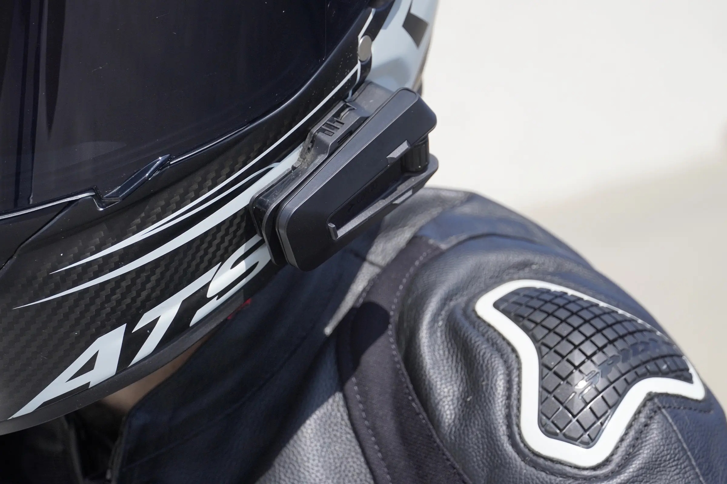 Cardo Packtalk Pro mounted on helmet