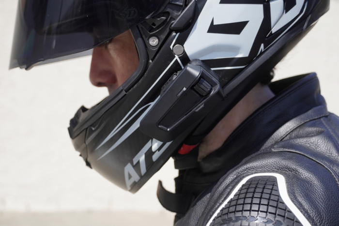 close up of man wearing helmet with Cardo Packtalk Pro mounted