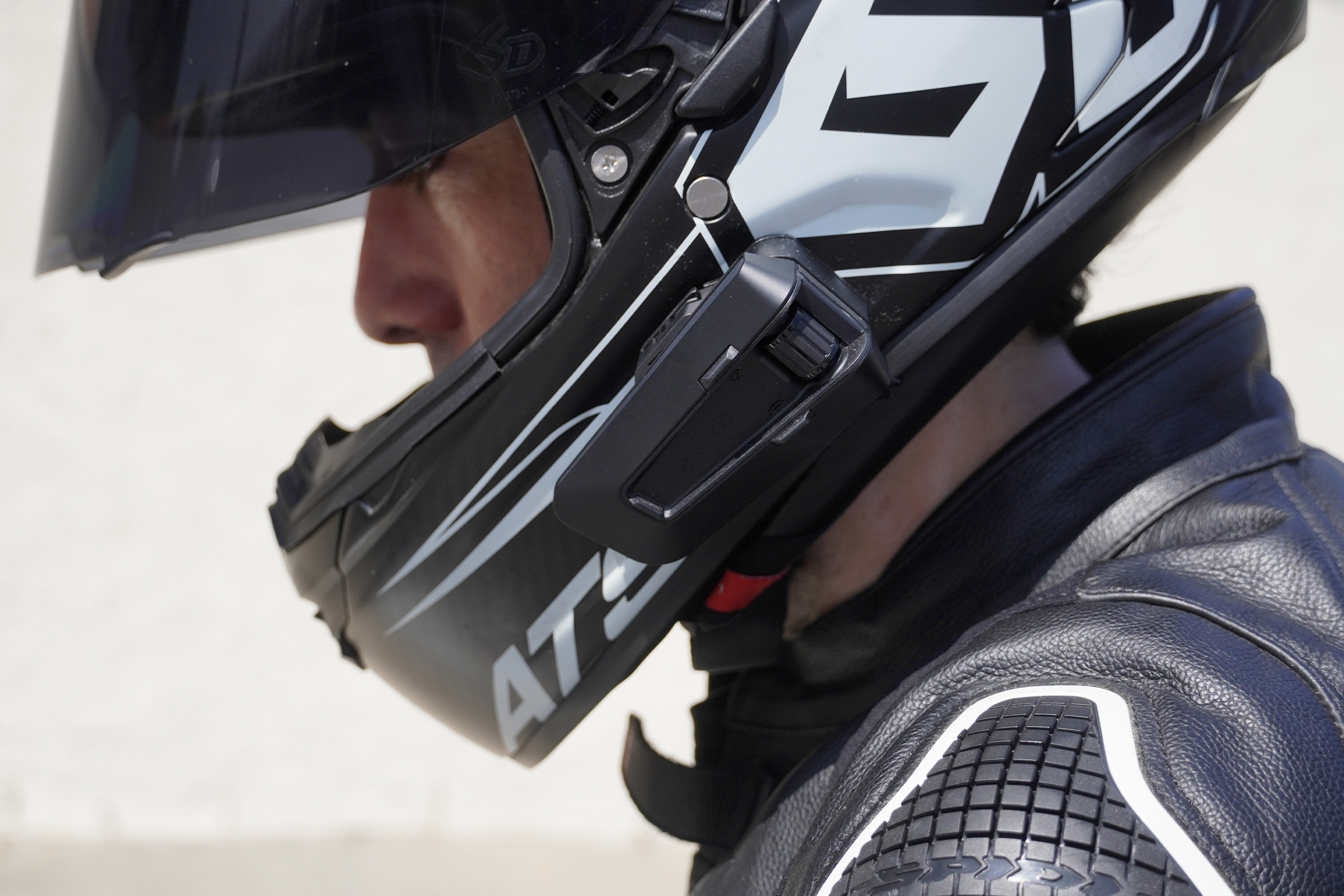 close up of man wearing helmet with Cardo Packtalk Pro mounted
