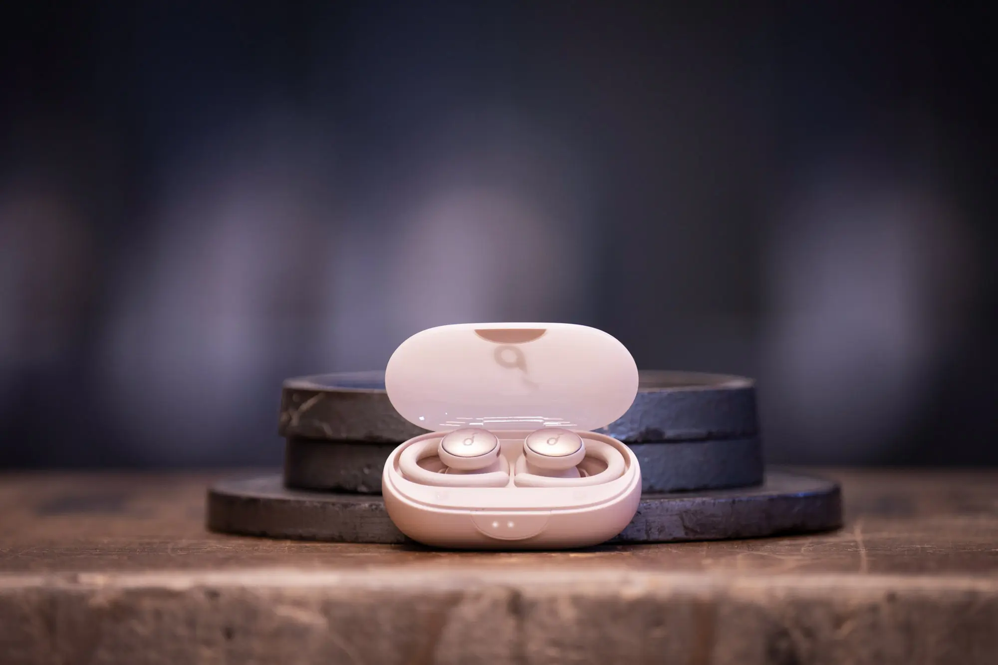 the anker sport x10 headphones framed with some plate weights