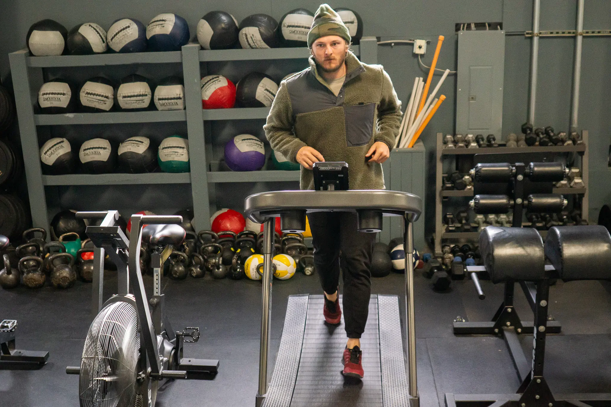 the author running on a treadmill, wearing the anker headphones