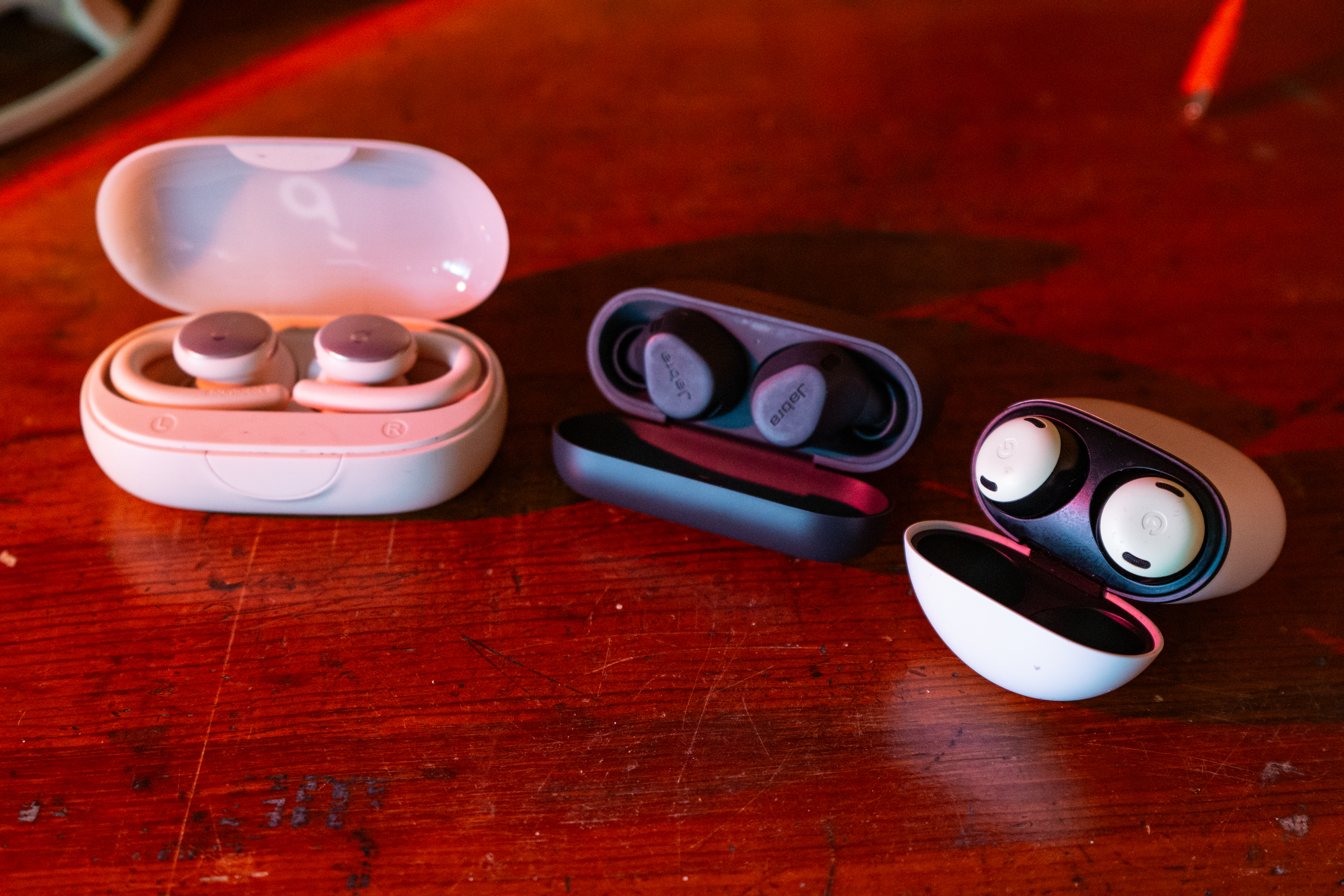 the anker sport x10 headphones beside the google pixel buds pro and jabra elite 8 active headphones