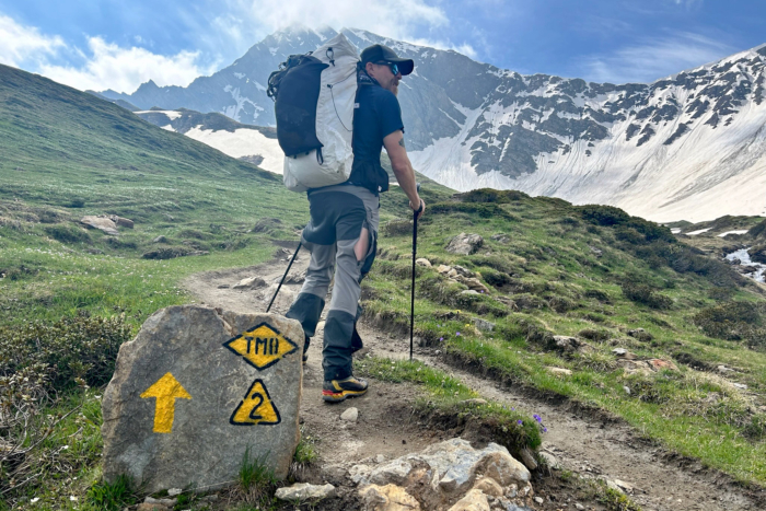 Hiker on the Tour du Mont Blanc trail wearing Fjallraven Keb pants