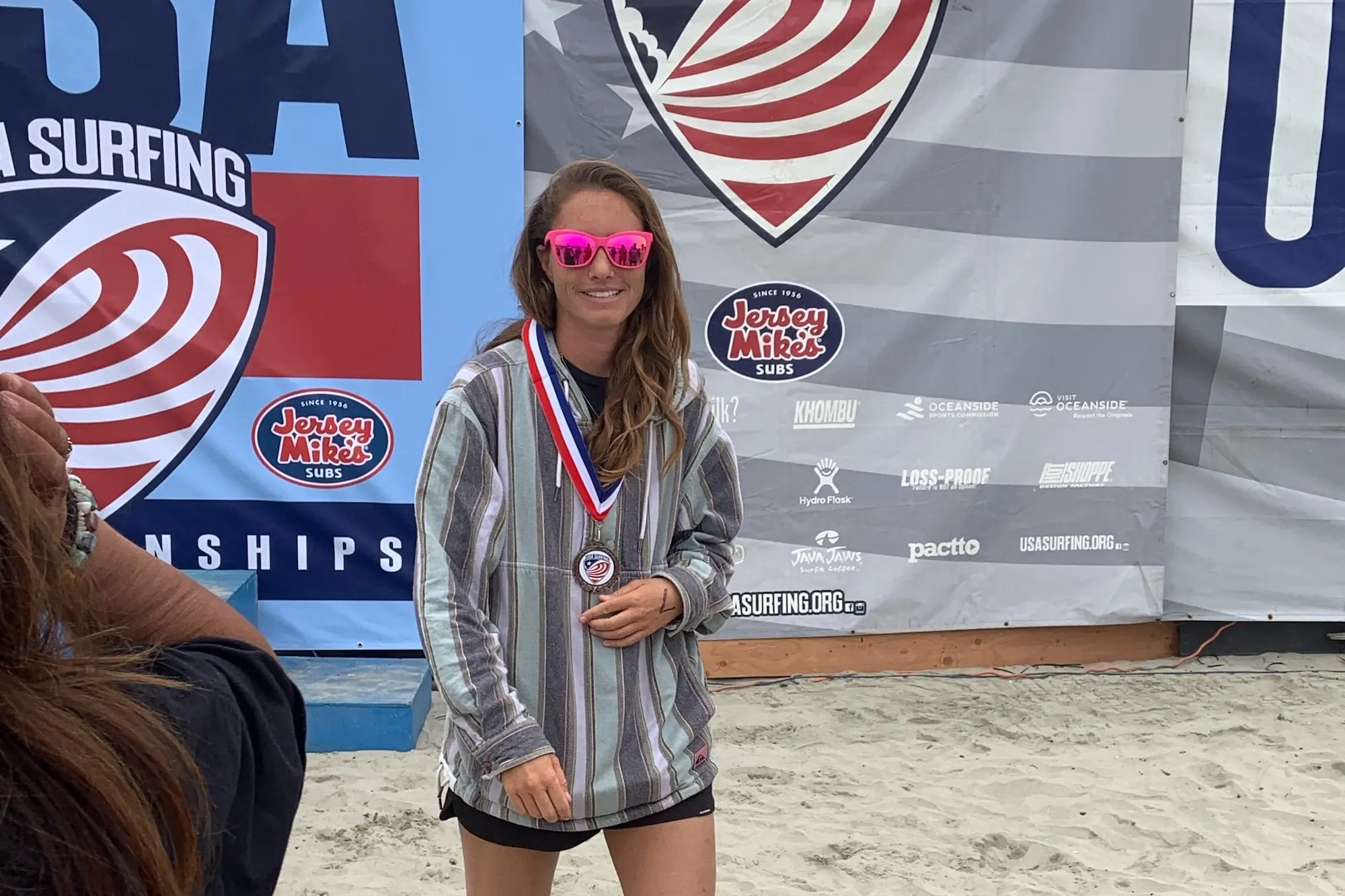 Rebecca Parsons wearing the Goodr Pop G sunglasses after receiving an award for a paddling event