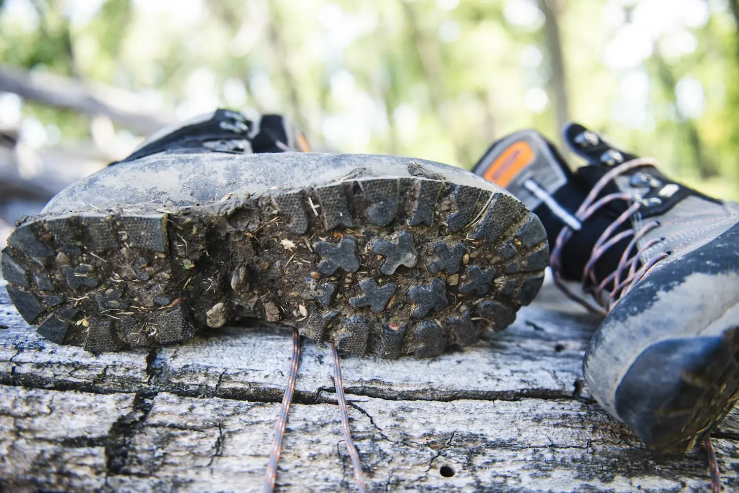 Sole of a Kenetrek hiking boot, showing its rugged, dirt-covered tread