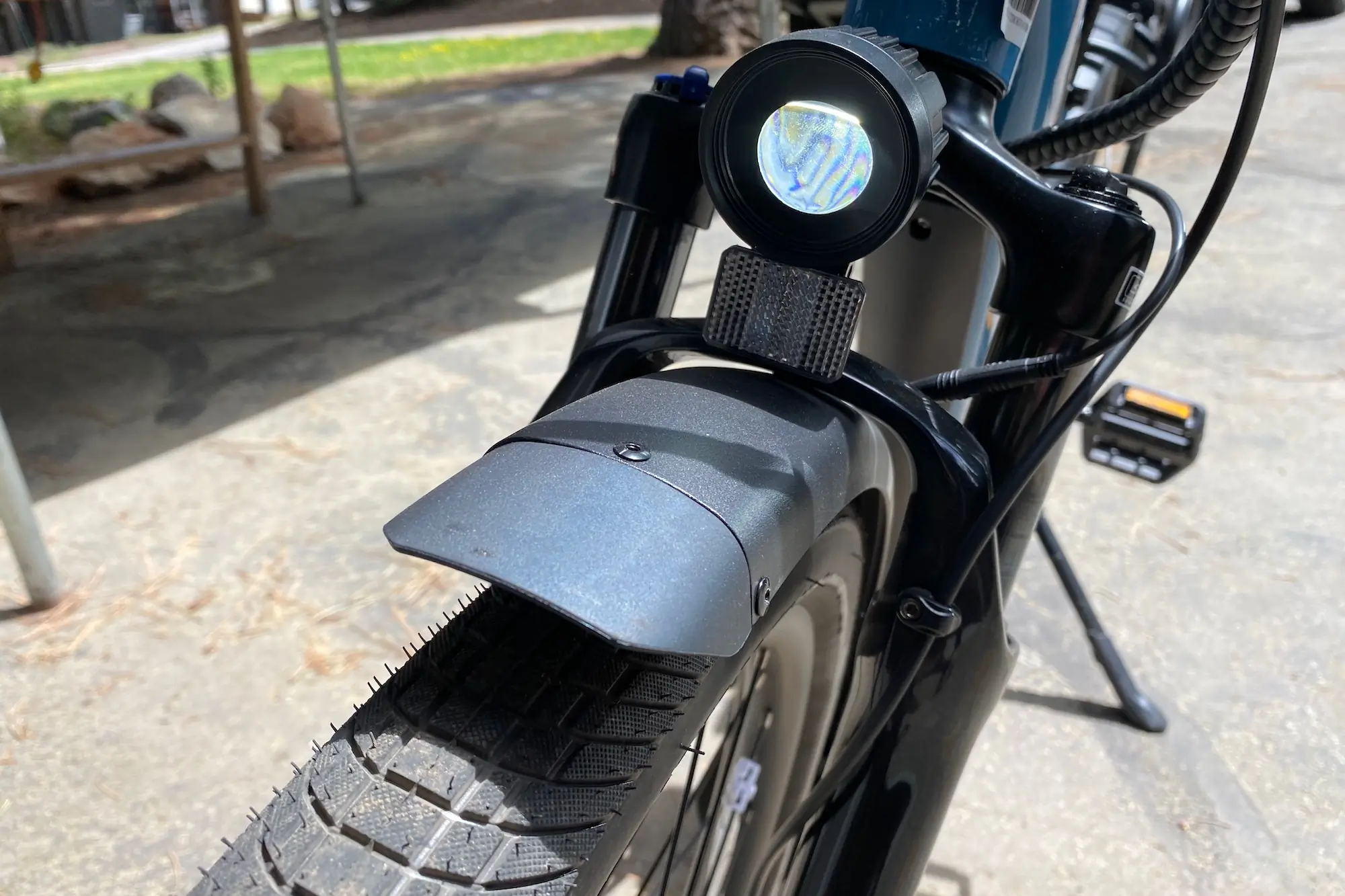 The headlight, front fender, and suspension fork on the Rad Power Radster Road electric commuter bike