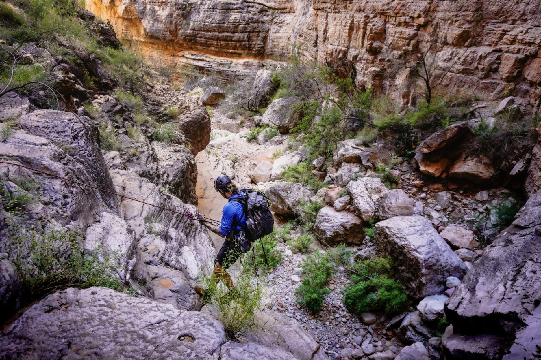 a hiker wearing the ula ultra circuit rappels into the grand canyon