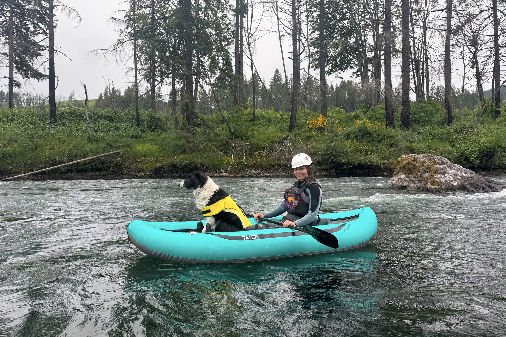 woman and dog inside blue aire tater kayak