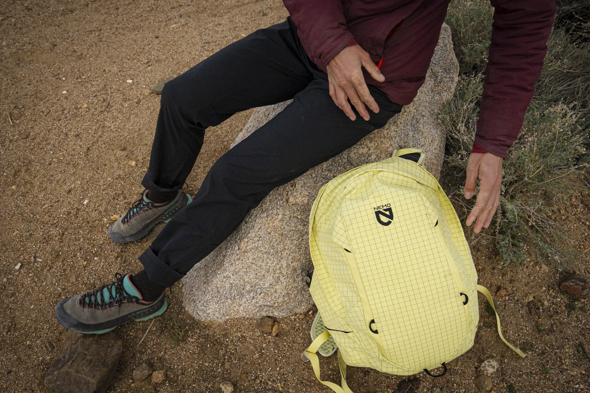 close up black patagonia quandary pants and yellow backpack