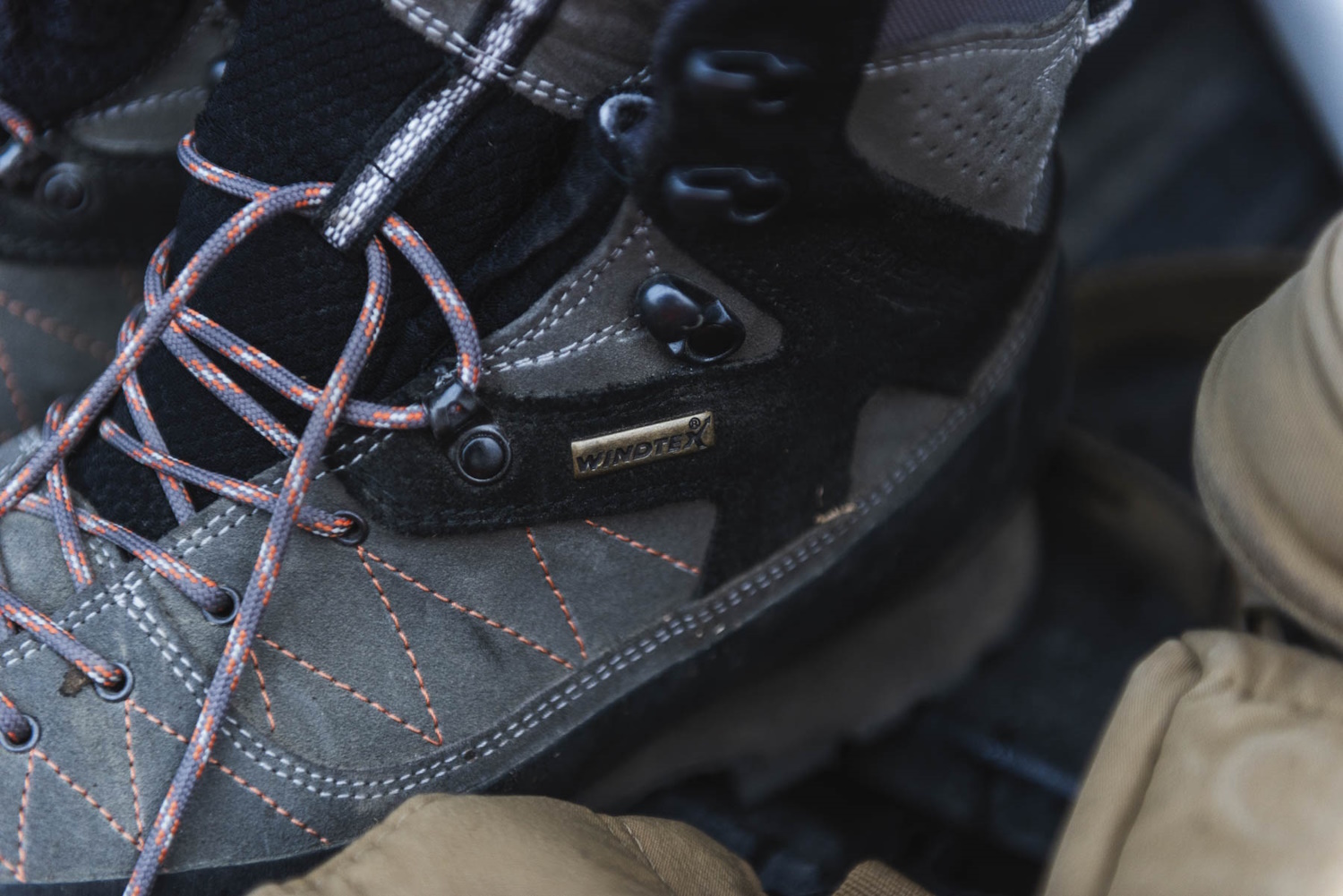 Close-up of a Kenetrek hiking boot with orange stitching and Windtex label