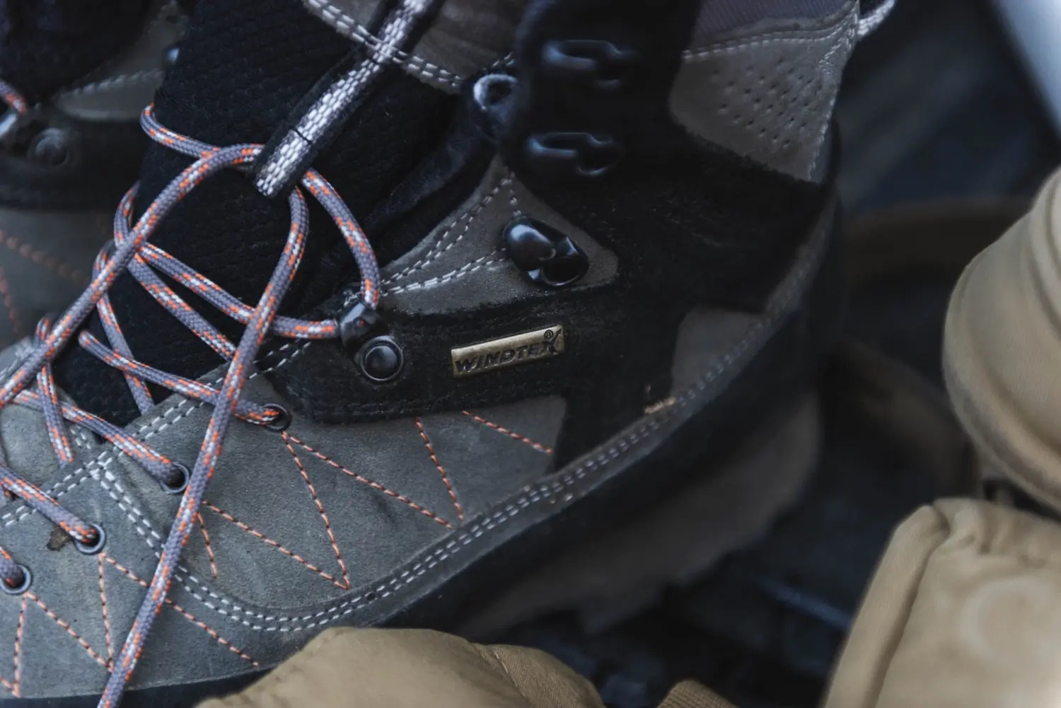 Close-up of a Kenetrek hiking boot with orange stitching and Windtex label