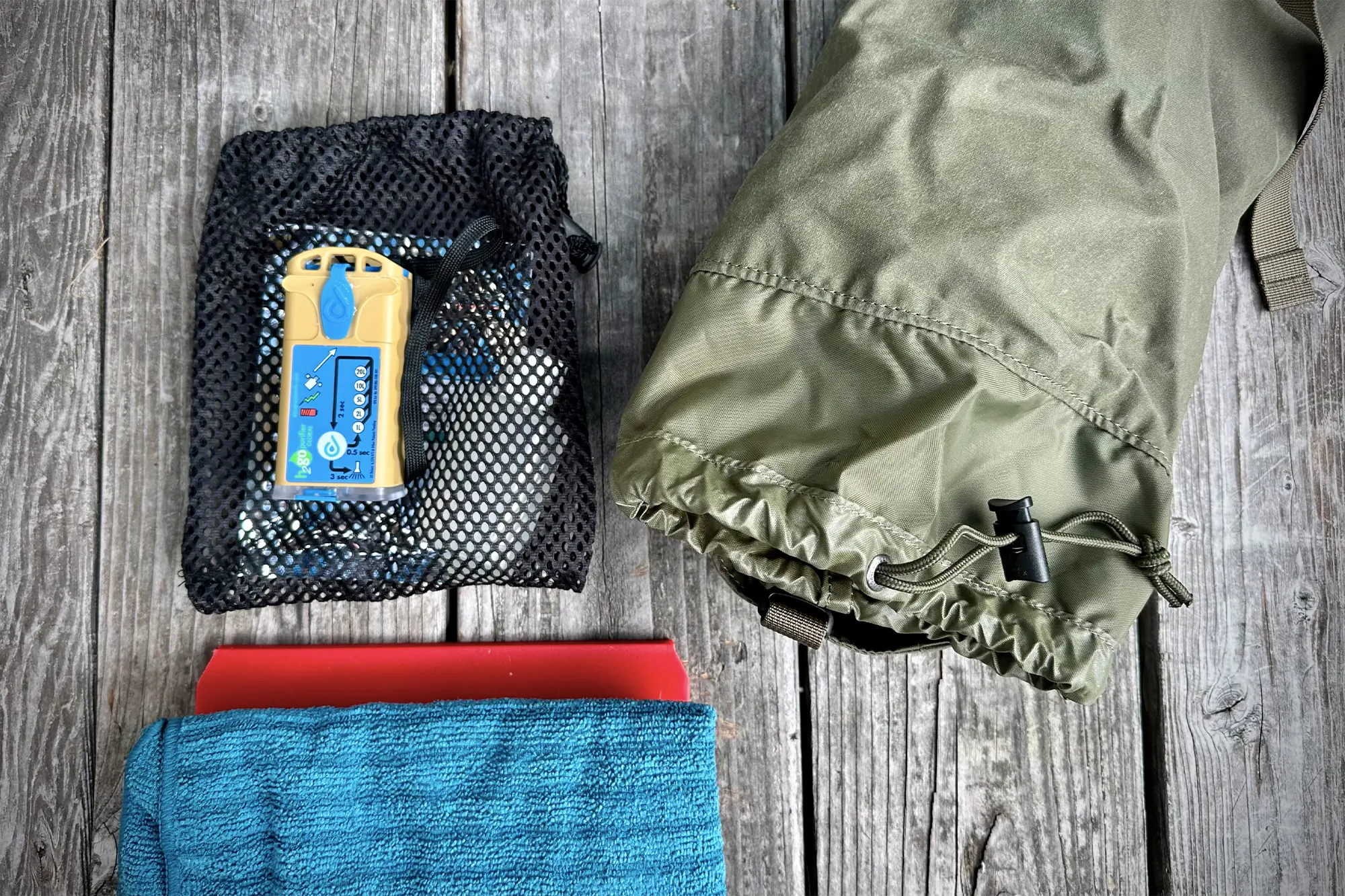 fjallraven kajka 35 side pocket shown with its contents next to it