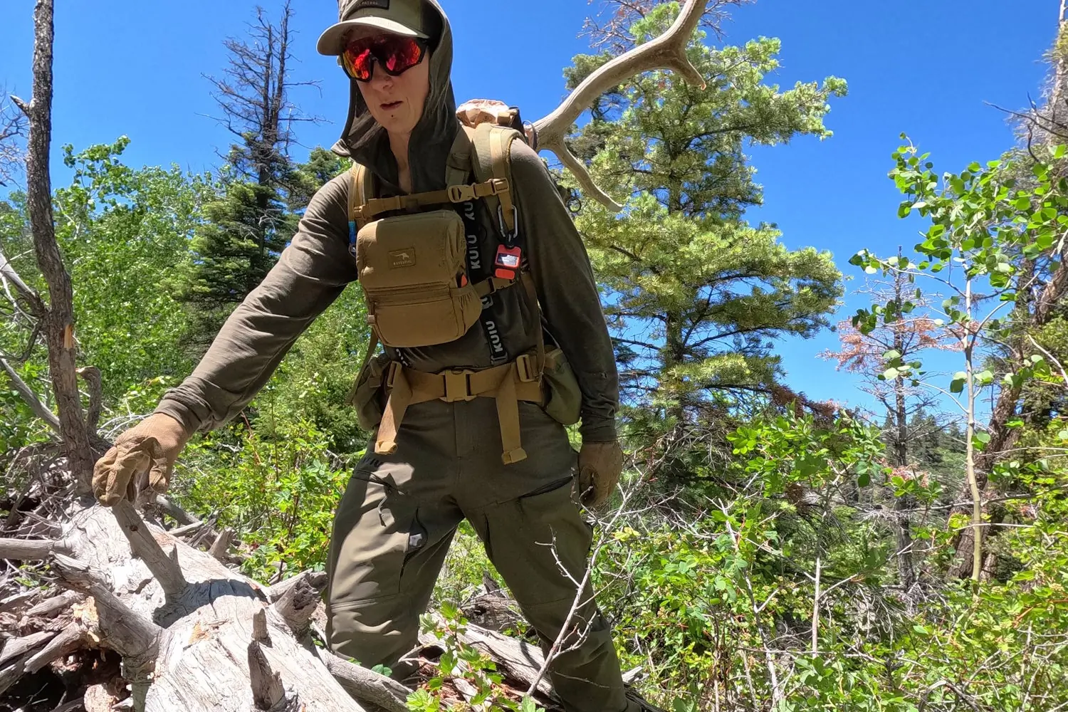 Hiker in KUIU PRO Women's brush pants, backpack, and gloves