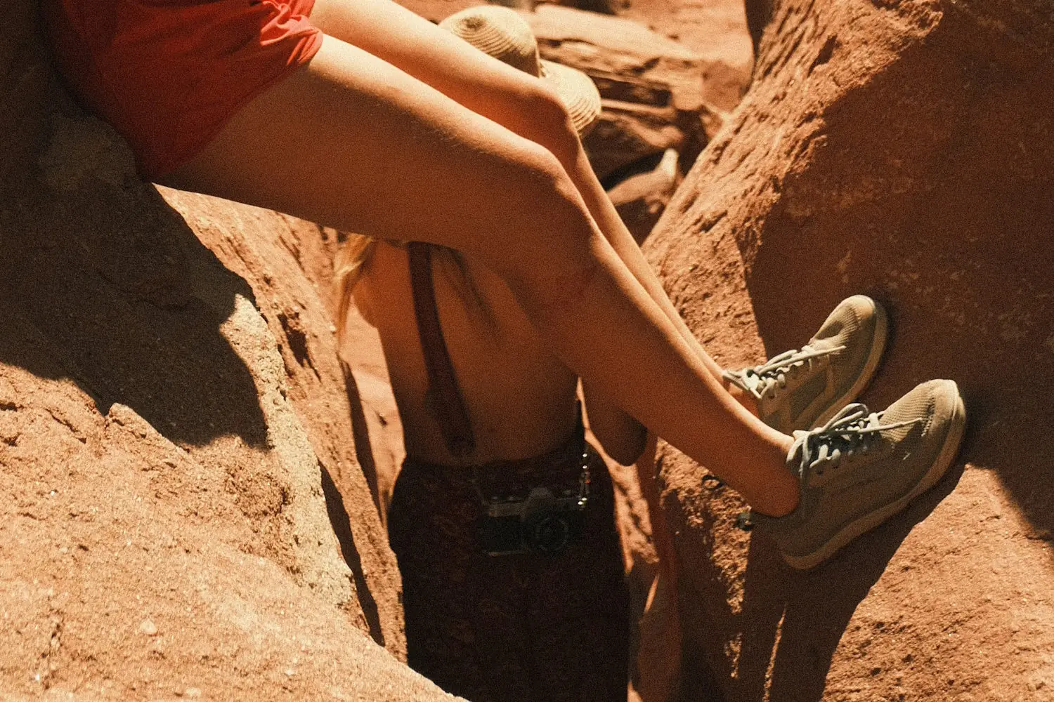 A hiker wearing Brewess 2.0 boots sitting on red rocks