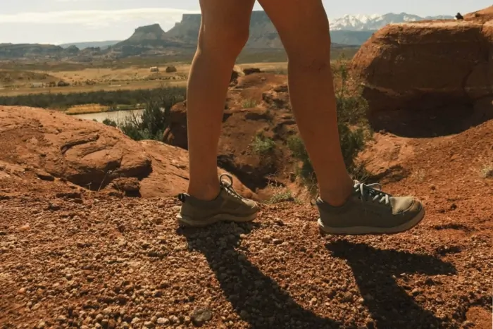 A hiker wearing Brewess 2.0 boots on a rocky trail
