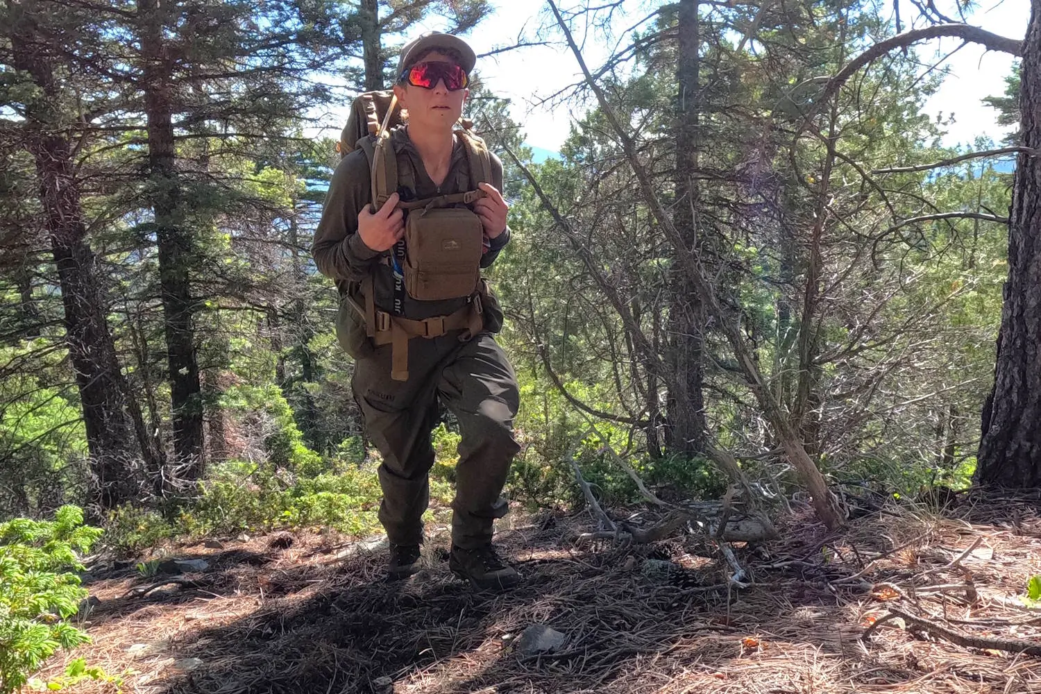 Hiker/hunter wearing KUIU Women's PRO Brush pants.