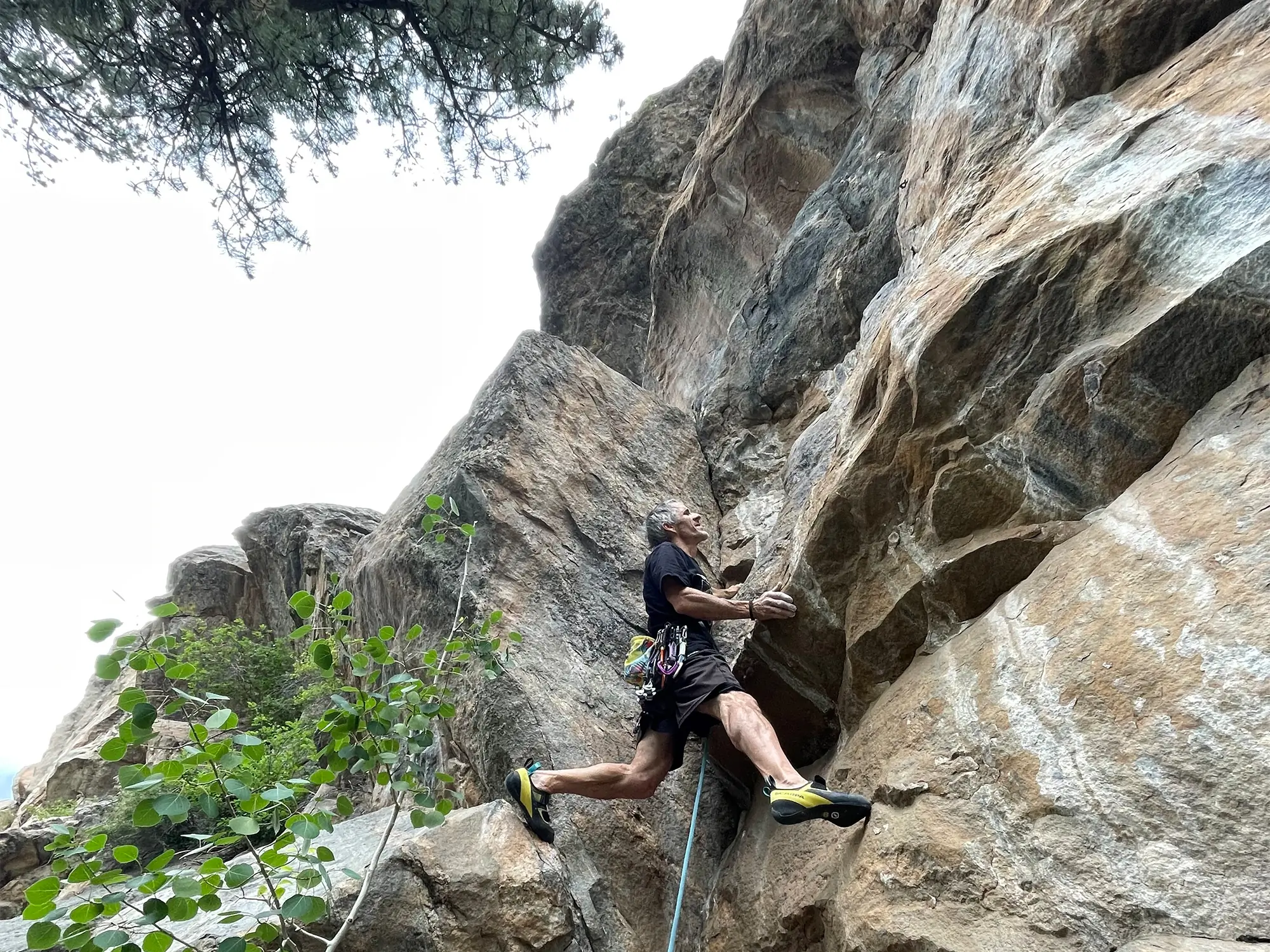 man climbing the gretels rock in scarpa arpia v climbing shoes