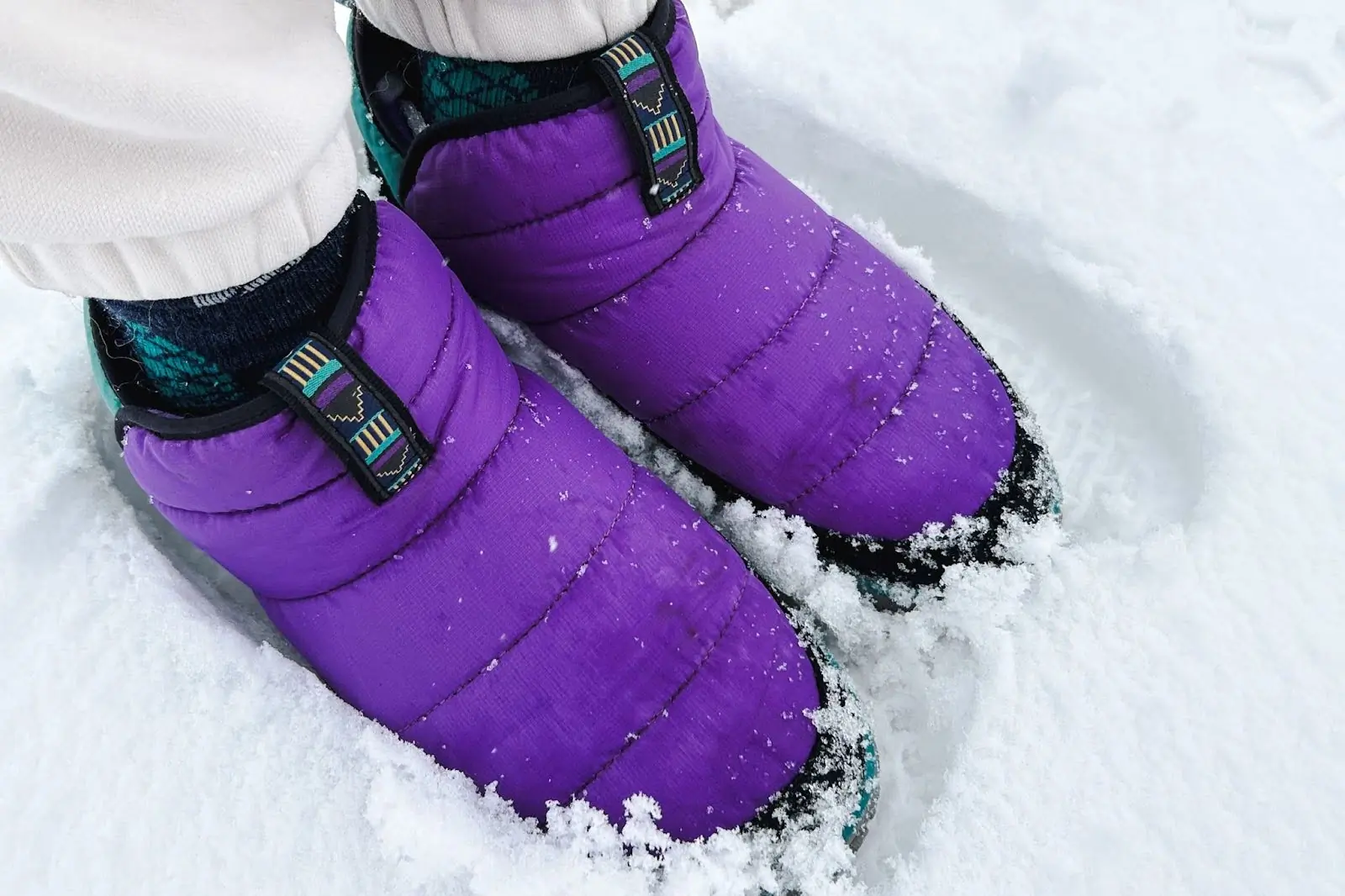 purple mountain classic quilted booties on snow