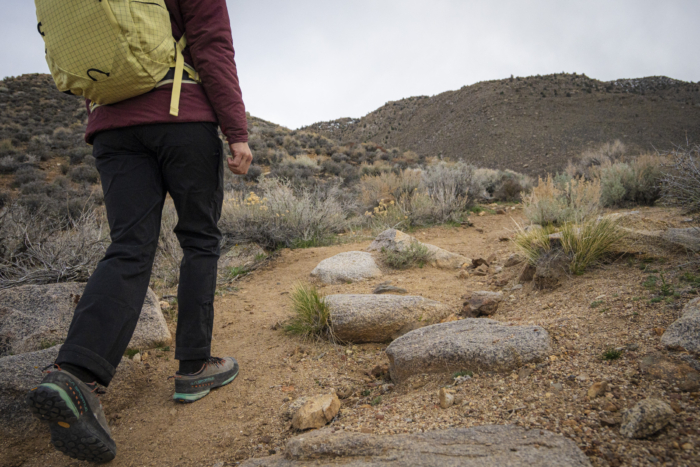 woman wearing black patagonia quandary pants and yellow backpack