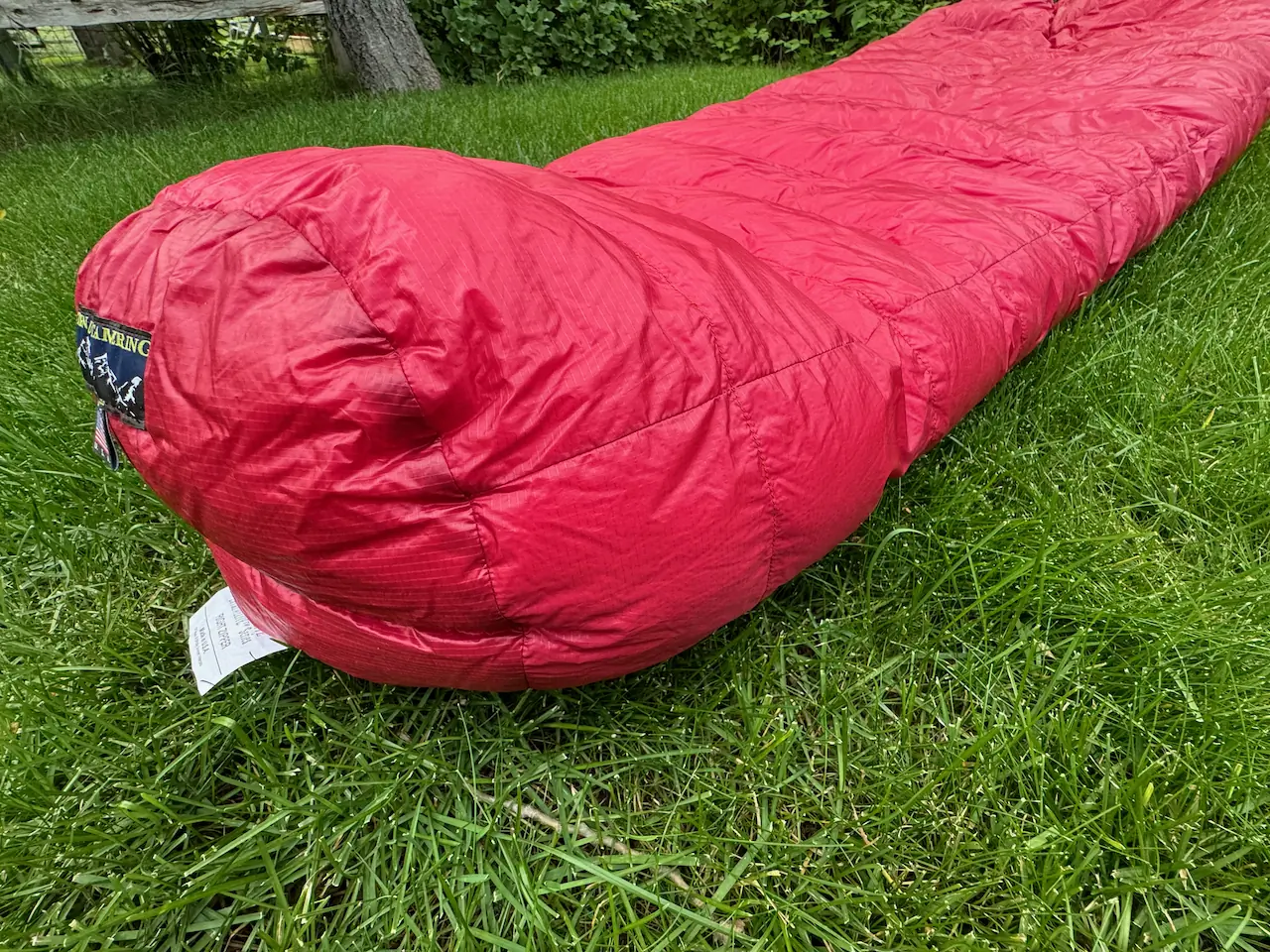 red alpinlite sleeping bag on grass