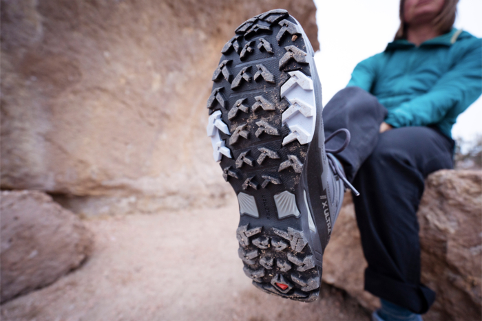 woman showing salomon x ultra 4 mid gtx hiking boot sole