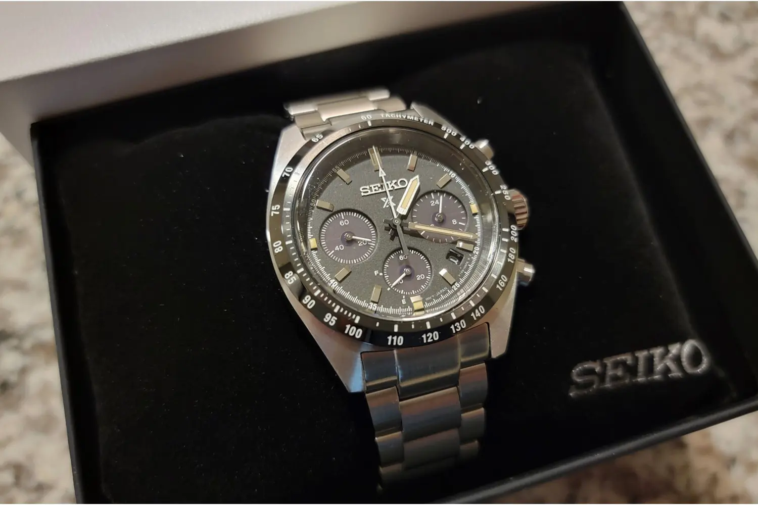 Seiko Prospex Speedtimer chronograph watch with a stainless steel bracelet, displayed in its black box